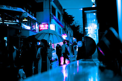 Crowd at illuminated city at night