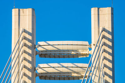 Low angle view of modern building against clear blue sky