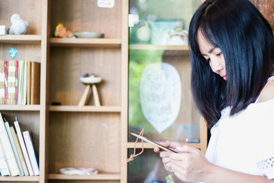 Midsection of woman holding book