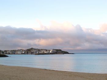 Scenic view of sea against cloudy sky