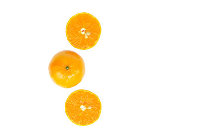 Close-up of orange fruit against white background