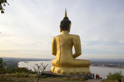 Statue of temple against cloudy sky