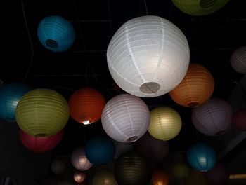 Low angle view of illuminated lanterns hanging on ceiling