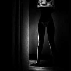 Rear view of a woman standing in the dark