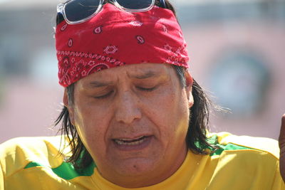 Close-up of man wearing red bandana