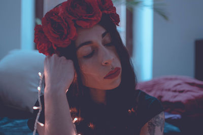 Portrait of young woman looking away at home