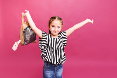 Portrait of happy girl standing against red background