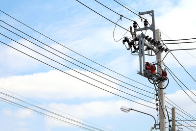 Low angle view of electricity pylon against sky