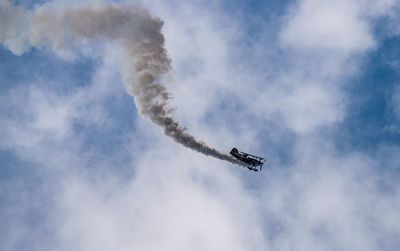 Low angle view of airplane flying in sky