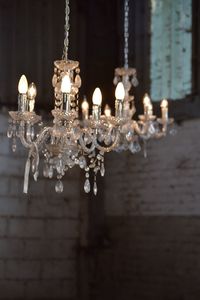 Close-up of illuminated chandelier hanging on ceiling