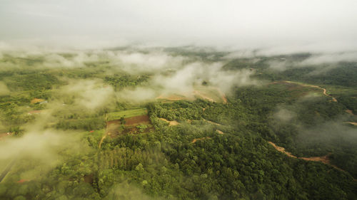 High angle view of green landscape against sky