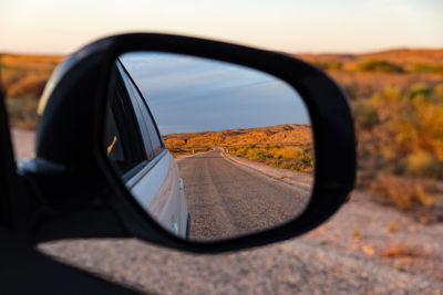 Reflection of sky on side-view mirror