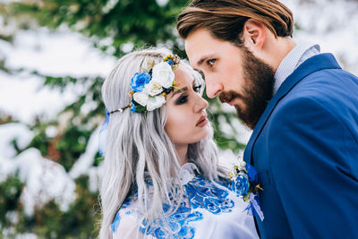 Portrait of young couple kissing outdoors