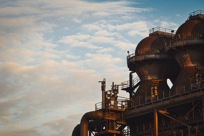 Low angle view of factory against sky