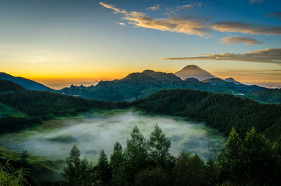 Scenic view of mountain range against sky during sunset