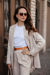 Young woman in white pantsuit and white t-shirt in city location