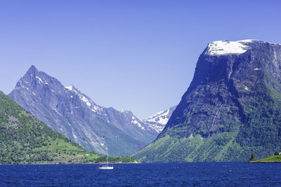 Scenic view of mountains against clear blue sky