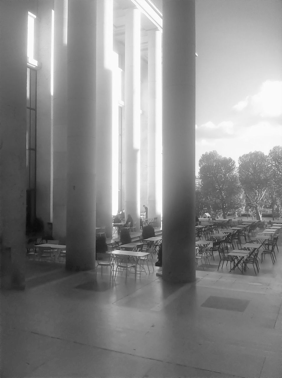 indoors, architectural column, built structure, architecture, empty, glass - material, absence, in a row, column, corridor, transparent, window, flooring, sunlight, day, no people, lighting equipment, reflection, ceiling, tiled floor