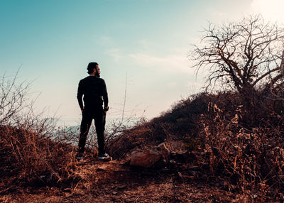 Full length of man standing on field against sky