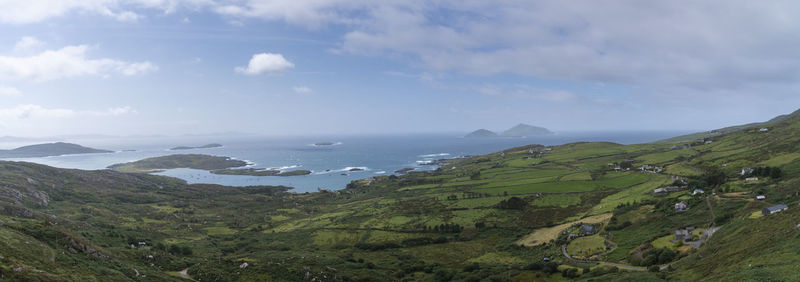 Scenic view of sea and mountains against sky