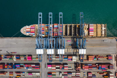 High angle view of commercial dock and containers ship loading on pier 