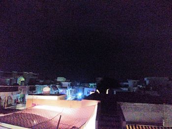 High angle view of illuminated buildings in city at night