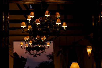 Low angle view of illuminated lamp at night