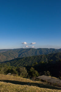 Scenic view of mountains against clear blue sky