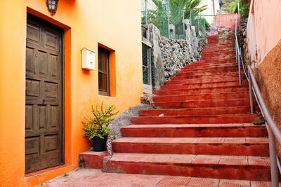 Low angle view of stairs along built structures