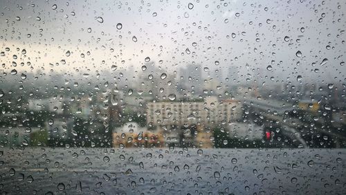 Full frame shot of wet glass window in rainy season