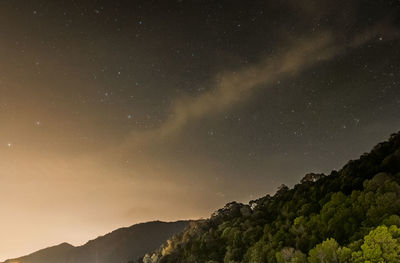 Low angle view of mountain against sky at night