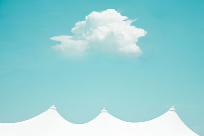 High section of white tent against blue sky