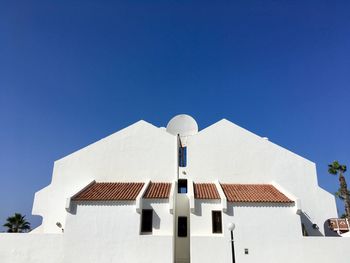 Low angle view of building against clear blue sky