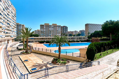 High angle view of swimming pool against cityscape