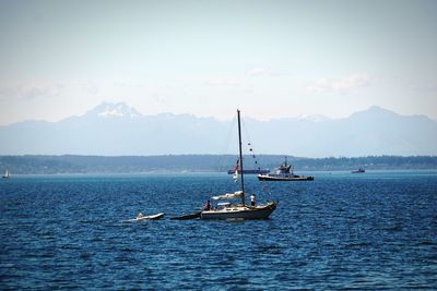 Boat sailing on sea against sky