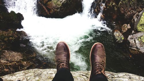 Low section of man standing in water