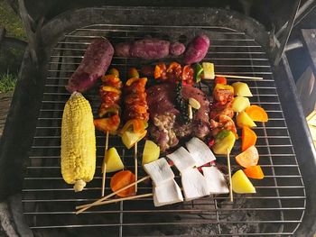 High angle view of meat on barbecue grill