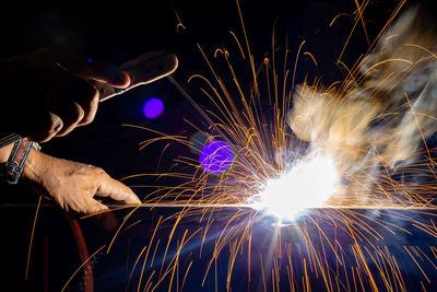 Low angle view of man working at night