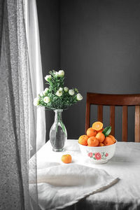 Fruits in vase on table at home