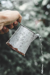 Close-up of hand pouring water