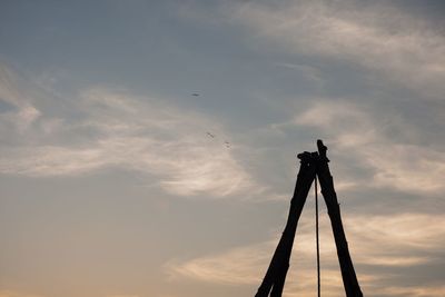 Low angle view of silhouette camera against sky during sunset