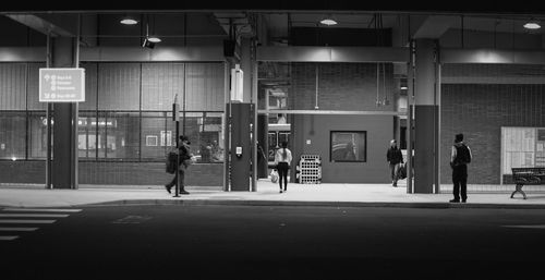 Group of people walking on road in city