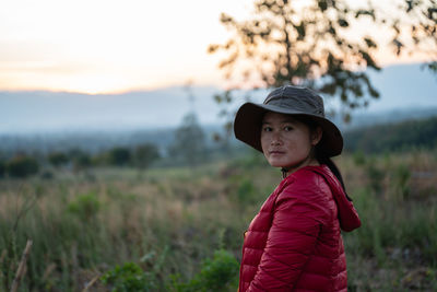 Side view of child looking away on field during sunset