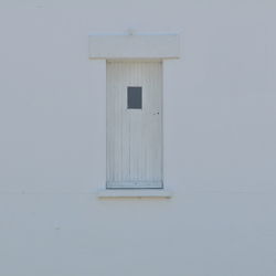 Closed door of white building