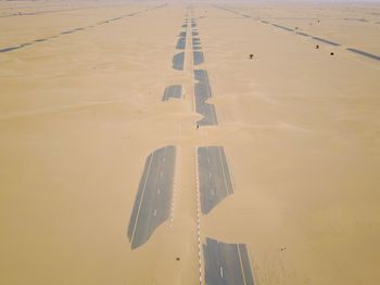 High angle view of umbrella on wet sand