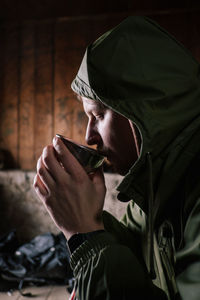 Midsection of man holding coffee cup