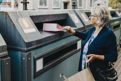 Woman recycling rubbish