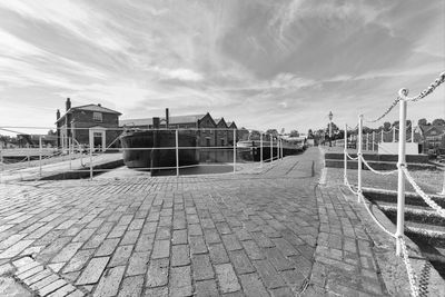 Promenade at harbor against sky