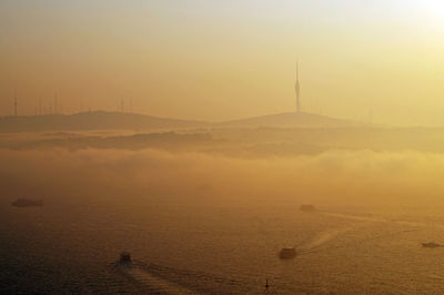 Scenic view of fog during sunset