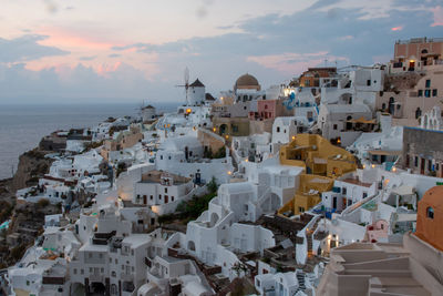 High angle view of townscape by sea against sky